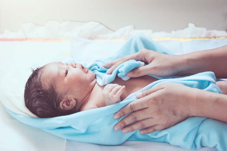 baby being dried gently after a bath when they have nappy rash